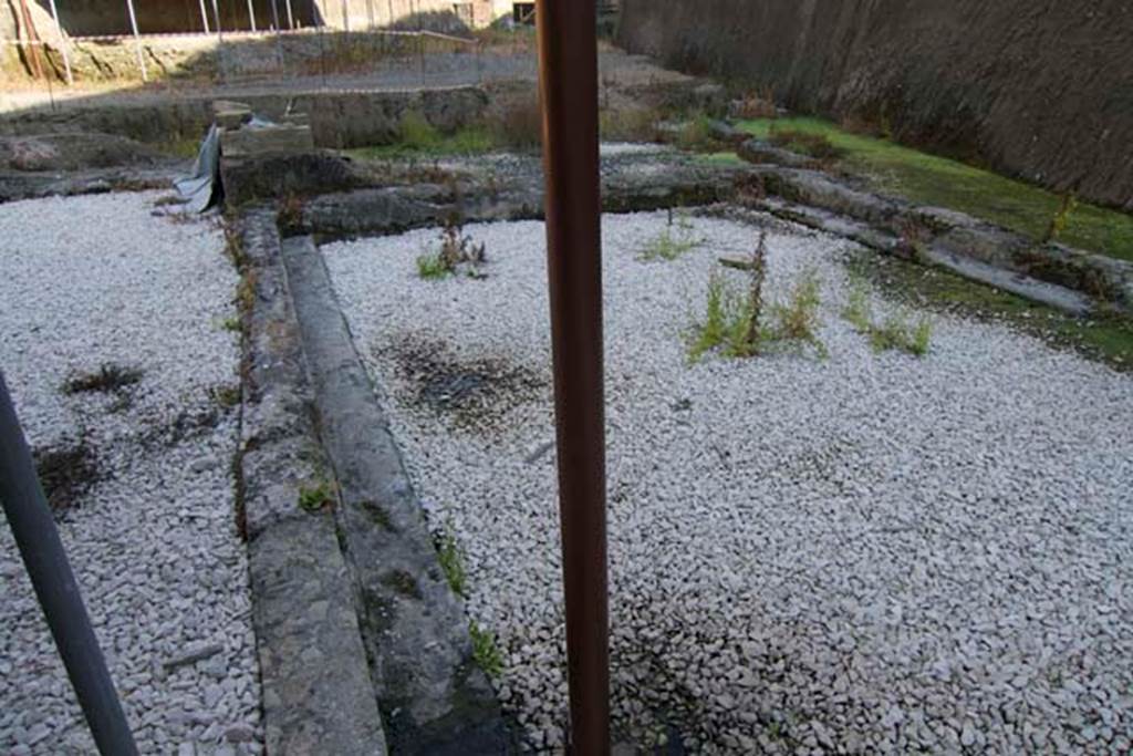 Villa dei Papiri, Herculaneum. July 2010.
Looking east along the large pool parallel to the coastline, towards the area of the small room with stairs and ramp providing access to the beach approximately six metres below. Photo courtesy of Michael Binns.